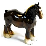 A 20thC Beswick pottery shire horse standing, 21cm high.
