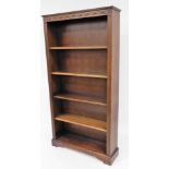 A 20thC oak open bookcase, of rectangular form with carved frieze and removable shelves, on a