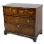 An 18thC walnut chest, of two short and two long drawers, each with a wide crossbanding, on