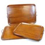 A set of three graduated Edwardian trays, each with metal handles, of oblong form, 55cm wide,