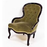 A 20thC open spoon back nursing chair, with overstuffed studded back, serpentine seat and cabriole