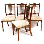 A set of four Edwardian dining chairs, each with pierced back splats, overstuffed seats in later