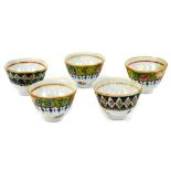 Five similar early 20thC Oriental tea bowls, polychrome decorated with a floral border to each,