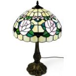 A late 20thC Tiffany style table lamp, with a floral shade, on turned stem and floral metal base,