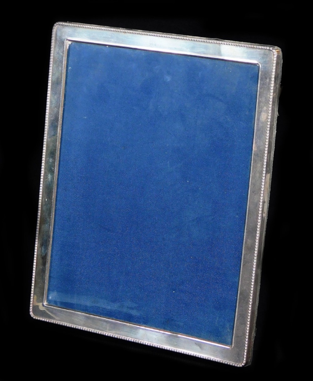 An Elizabeth II silver photograph frame, of oblong form with a bead outline, plain interior and