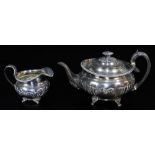 A George IV silver two piece tea service, comprising teapot of compressed circular form, with floral