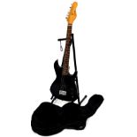 An Encore six string electric guitar, in black colour way, 99cm high, with canvas case and stand.