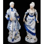 A pair of 20thC continental figures of a lady and gentleman, each in formal dress on shaped floral