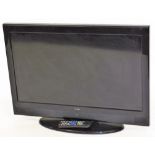A Technika 31 inch television, in black trim with remote control and wire.