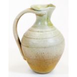 A 20thC Studio pottery ewer, with moulded lip, double handle and textured body, on circular foot,
