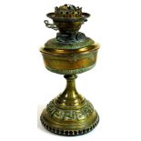 An early 20thC brass oil lamp base, with a Greek key decoration to the lower section, 36cm high.