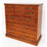 An Edwardian walnut chest of drawers, with moulded top, raised above bonnet drawer flanked by two