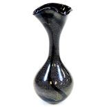 A 20thC studio Our Glass vase, with a flared rim, plain stem and bulbous body, in black yellow