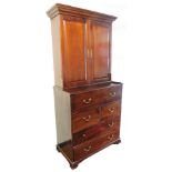 An early 19thC mahogany secretaire bookcase, the dentil top raised above a pair of panelled doors,