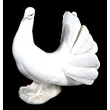 A 20thC Lladro figure of a dove, printed marks beneath, 20cm high.