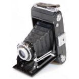 A 20thC vintage Zeiss Ikon folding camera, in pressed black, with Novar-Anastigmat 1:6.3 f-105mm