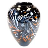 An Ourglass studio glass vase, of shaped form, in orange and white speckles on black ground,