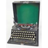 A vintage Imperial typewriter, in black trim, with pressed case, 14cm high.