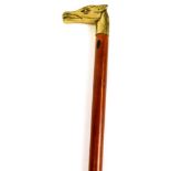 A walking stick with brass horse head top, and plain tapering stem with rubber end, 86cm high.