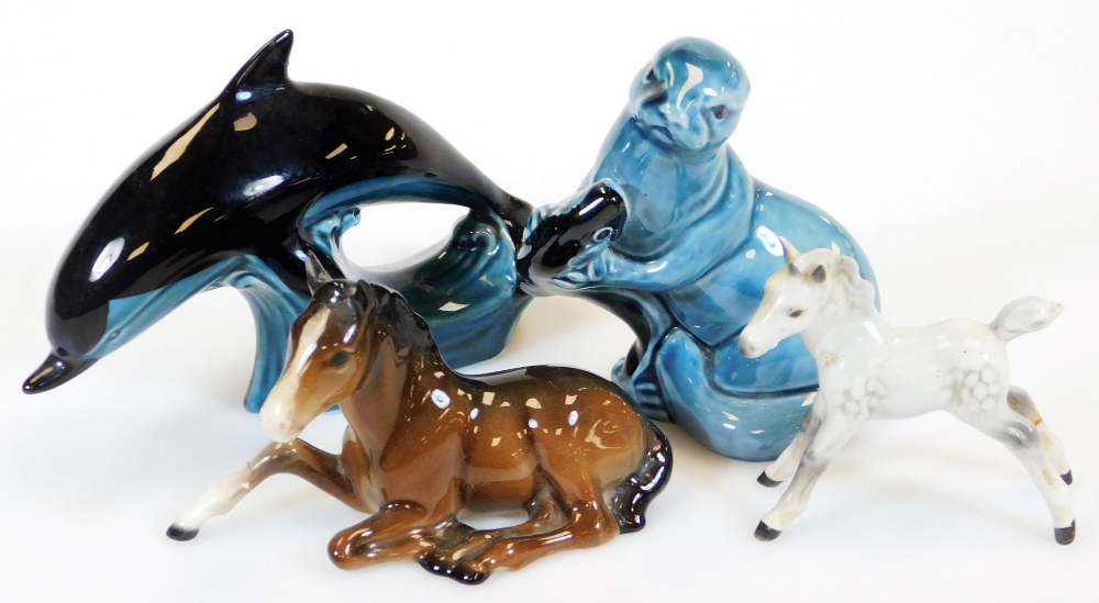 A Beswick foal, number 915, recumbent, 13cm wide, a grey foal, Poole dolphin and an otter, marked