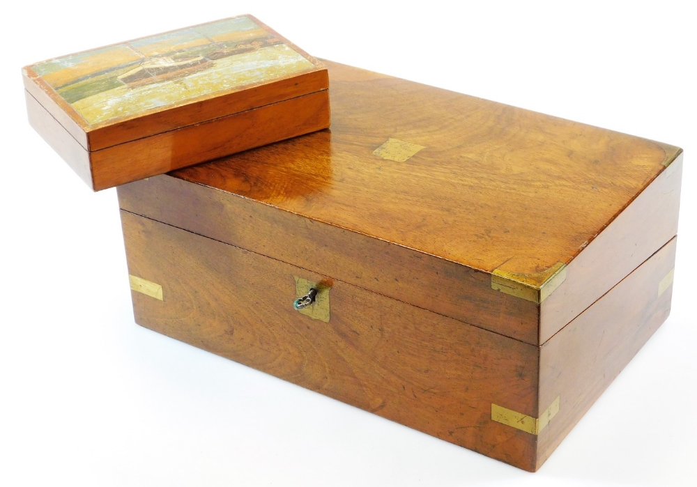 A mid 19thC mahogany campaign writing box, with brass mounts and a vacant shield shaped cartouche to