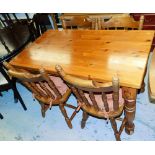 A pine table of rectangular form on turned legs, four pine chairs with shaped cresting rails. (5)