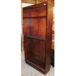 A mahogany finish open bookcase, with dentil top.