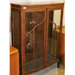 A mid 20thC bow front display cabinet, with astragal glazed doors on compressed cabriole pad feet.