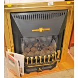 A Flavell Inset gas fire, with mock coals and handbook, partially boxed, 63cm high. 58cm wide, 21cm