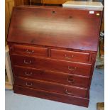 A stained bureau, with fall, fitted interior and two short and three long drawers, on a block base.