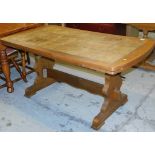 An oak tile topped extending dining table, on shaped legs terminating in castors.