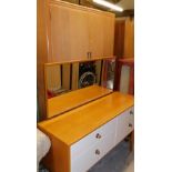 A lightwood mirror back dressing table, of four short drawers on square legs and a two door