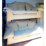 A two piece lounge suite in cream material, comprising three seater 210cm wide and a two seater