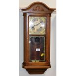 A 20thC Highlands wall clock, with 13cm wide plate, Roman numeric dial and eight day movement, oak