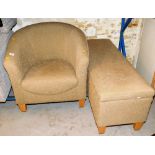 A tub chair, on tapering beech legs and a rectangular storage compartment or foot stool.