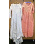 Vintage wedding dress in white, with raised floral pattern, another evening dress in orange.