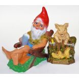 A Celluloid garden gnome, pig and duck door stop. (2)