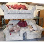 A three piece lounge suite, comprising two seater settee and two armchairs, each in floral cream