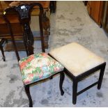 An early 20thC heavily carved poker work chair, with pierced back splat and a stool with rectangular