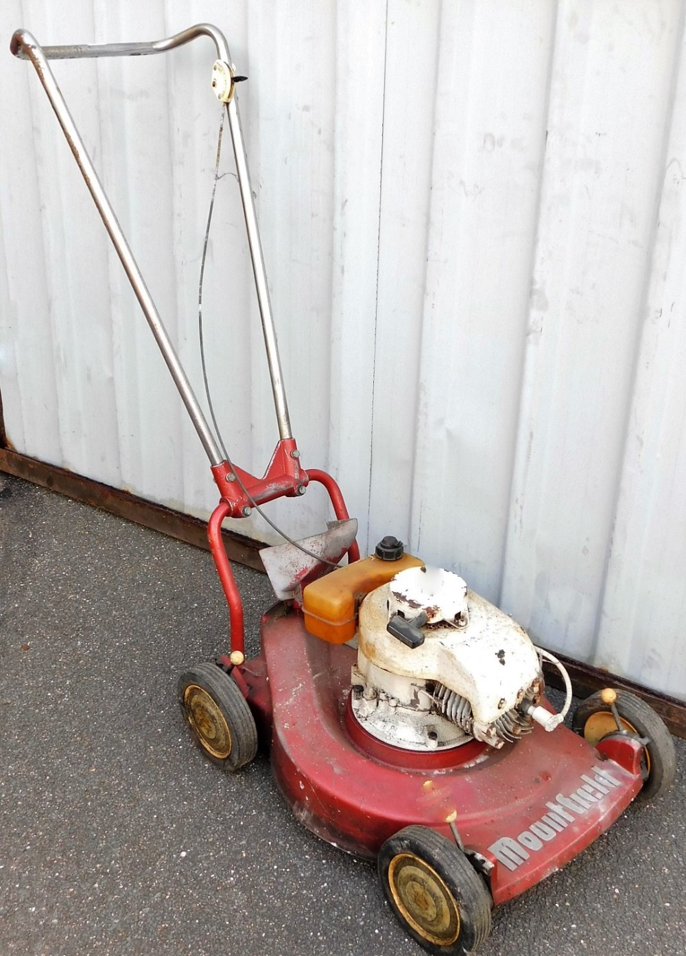 A Mountfield rotary mower, in red colour way.