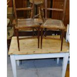 An early 20thC slatted pine side table, with square tapering legs, and two horizontal backed bergere