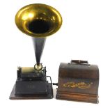 An Eddison Gem phonograph, with brassed and ebonised metal trumpet, in an oak case.