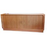 A Dyrlund Danish teak sideboard, the top and sides with rounded corners, above two sliding doors enc