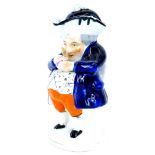 A 19thC Staffordshire snuff taking Toby jug, dressed in blue jacket and orange trousers, with lid, l