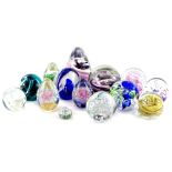 A collection of glass paperweights, various colours and models to include Langham, Caithness etc.