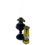 A Victorian ebonised spelter on a lamp base, with brass fitting, 33cm high, a glass chimney and a pr