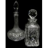 A square section cut glass decanter and stopper, and a bottle shaped decanter with faceted stopper.