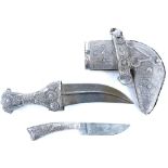 A vintage white metal Middle Eastern jambaya dagger, white metal mounted with sheath, 25cm long.