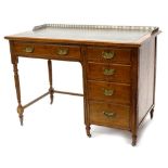 A late 19th/early 20thC Maple and Co oak desk, the top with a three quarter pierced brass gallery an