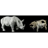 A porcelain model of a rhinoceros, 33cm long, and a studio ceramic pig, in distinct initials, BM, to